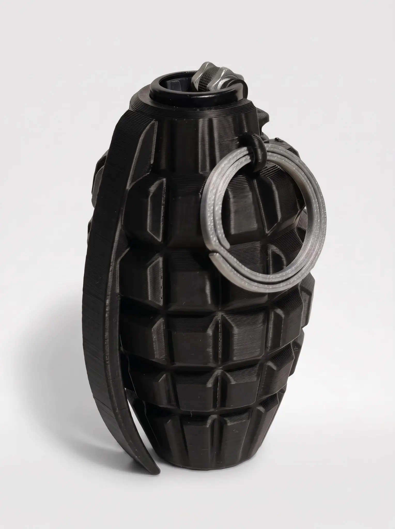 Matte-black tactical grenade Clipper lighter case with a metallic pull ring